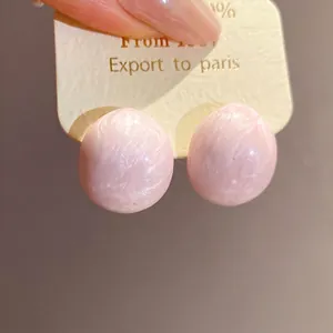 Elegant pink oval enamel stud earrings featuring a delicate marbled texture finish.