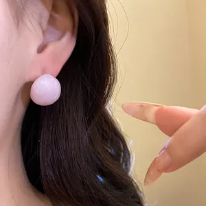 Elegant pink drip oil oval stud earrings with a minimalist luxury design on a model ear