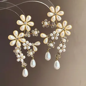 Macro view of vintage floral earrings featuring elegant pearls and sparkling rhinestones.