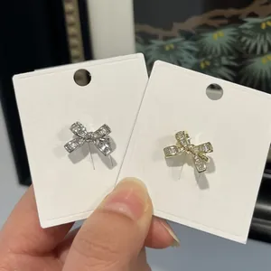 Elegant crystal bow ear cuffs available in gold and silver finishes, non-pierced design