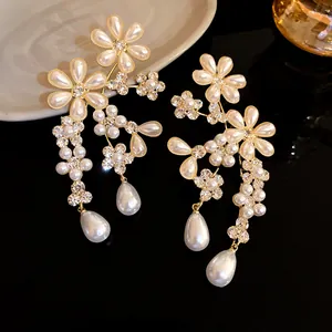 Detailed macro view of vintage floral earrings featuring sparkling rhinestones and elegant pearls