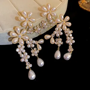 Macro detail of luxury flower earrings with white pearls and sparkling rhinestones