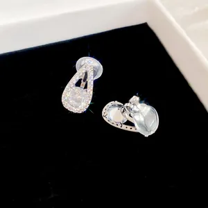 Detailed macro shot of elegant silver teardrop clip-on earrings with sparkling cubic zirconia