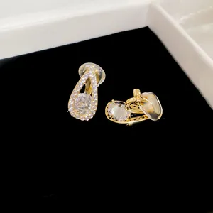 Close-up of 18k gold plated waterdrop clip-on earrings with sparkling cubic zirconia