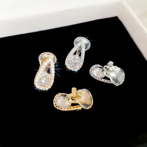 Detailed macro view of sparkling 18k gold plated zircon teardrop ear clips for non-pierced ears