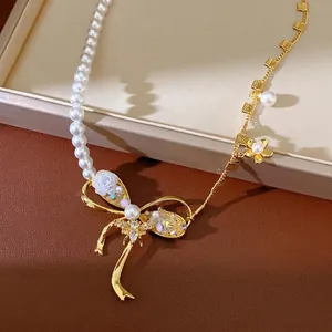Elegant asymmetrical pearl necklace with gold bowknot, bee and floral zircon charms