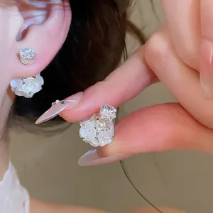 Close-up detail showing sweet floral pearl earrings with front-back design and zircon