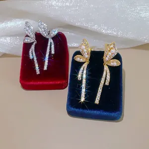 Elegant 18k gold plated butterfly ear clips featuring sparkling zircons and pearls
