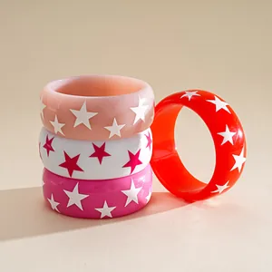 Vibrant resin bangles featuring white and pink star patterns in dopamine style colors