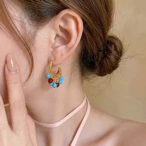 Elegant 18k gold plated C-shaped ethnic earrings with vibrant blue and red resin beads.
