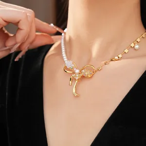 Detailed macro shot of luxury bow pendant necklace featuring pearls and zircon bee motif