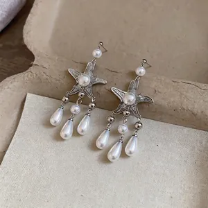 Élégantes boucles d'oreilles style français avec étoile de mer et perles pour femme