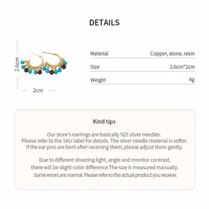 Product detail view of 18k gold plated C-shaped earrings with stone beads and resin.