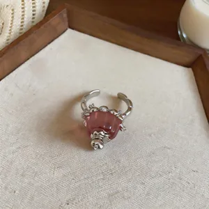 Macro detail of a unique pink resin pudding ring with shimmering zircon embellishments