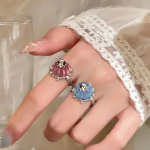 Close-up detail showing cute pink and blue resin pudding rings with silver-colored settings