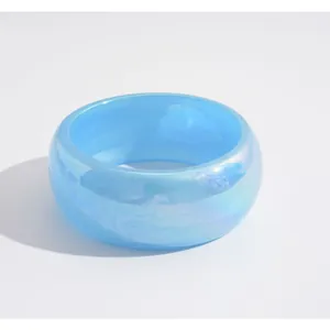 Iridescent light blue resin bangle bracelet with a thick circular design for women