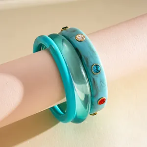 Detailed view of a three-piece retro resin bangle set with marble patterns and rhinestones.