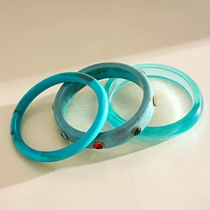 Detailed shot of three-piece marbled resin bangles with colorful rhinestones