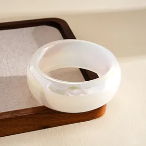 Detail showing the pearlescent iridescent finish of the white resin wide bangle