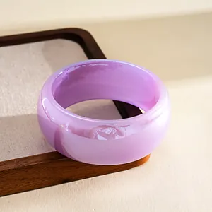 Detail shot of a translucent lavender resin bangle with subtle iridescent marble finish