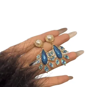 Vintage palatial peacock feather drop earrings with pearls and blue enamel for women