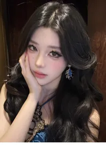 Elegant vintage court style teardrop earrings with blue gemstones on an Asian model