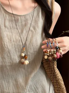 Handmade forest acorn necklace detail showing various styles and wooden beads