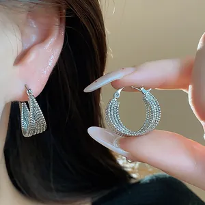 Detailed view of 18k silver plated hoop earrings with textured beaded mesh design