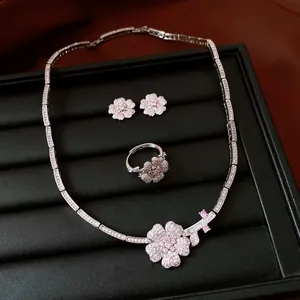 Detailed view of luxury zircon flower jewelry set including necklace, ring, and earrings