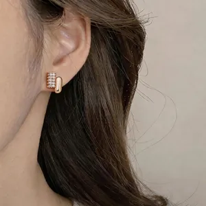 Elegant French style oval stud earrings with shiny zirconia stones in polished gold finish