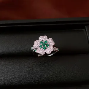 Macro view of a luxury floral ring set with sparkling green and white zircon stones