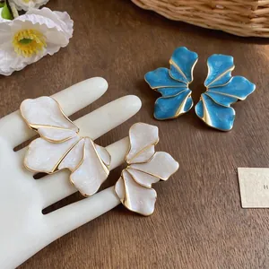 Unique petal-shaped enamel earrings with gold-plated metal edges and wavy glaze