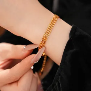 Elegant 18k gold plated multi-layer chain bracelet for women, close-up view on wrist.