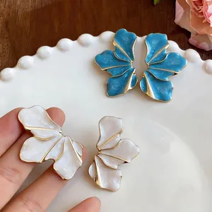Elegant designer enamel flower petal stud earrings with gold metal trim in white and blue