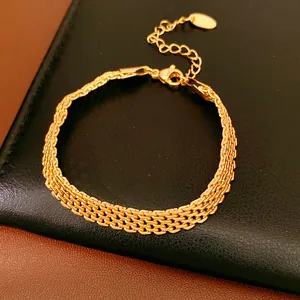 Detailed view of 18k gold plated triple-row woven mesh chain bracelet with lobster clasp