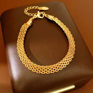 Detailed view of luxury 18k gold plated mesh chain bracelet on a dark brown jewelry box