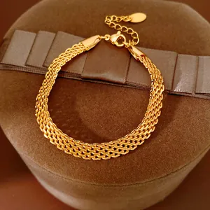 Detailed view of 18k gold plated mesh chain bracelet on brown velvet gift box.