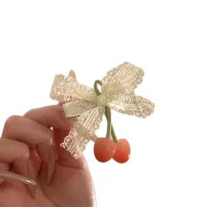 Sweet pastoral style cherry hair clip featuring a delicate lace bow and ribbon