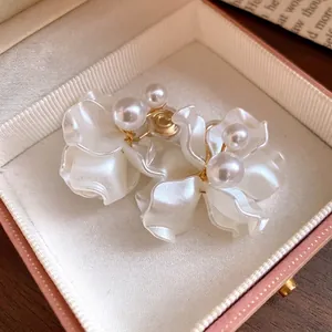 Elegant white pearl petal clip-on earrings presented in a luxury jewelry gift box