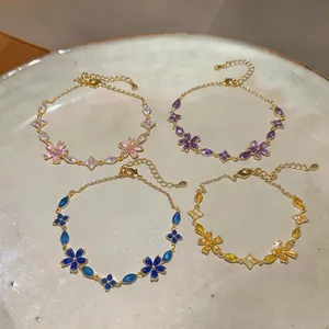 Detailed view of four elegant French-style flower bracelets with colorful zircon crystals