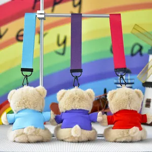 Close-up of three colorful plush teddy bear keychains with matching wrist straps