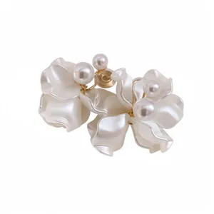 Elegant white petal clip-on earrings with faux pearls, minimalist fashion jewelry.