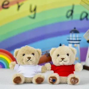 Two small brown plush teddy bears wearing white and red t-shirts with I heart FLY embroidery on paws