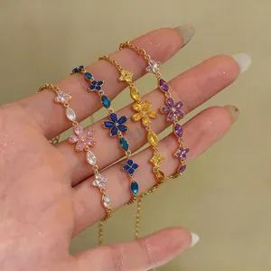 Detailed view of four colorful zircon flower bracelets in pink, blue, yellow, and purple