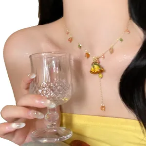 Elegant eternal yellow rose flower pendant necklace on model for a chic clavicle look.