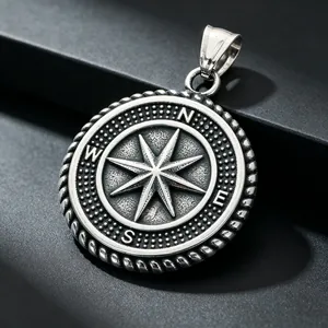 Close-up detail of a vintage stainless steel compass rose pendant for men's jewelry
