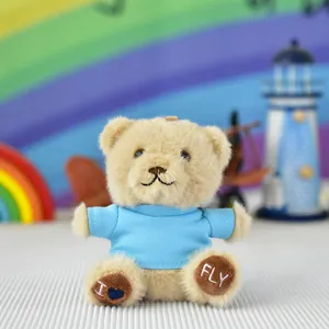 Close-up view of a cute plush teddy bear wearing a blue t-shirt with I Love Fly embroidery