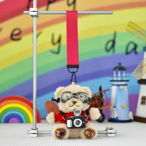 Close-up of a cute pilot teddy bear plush keychain with goggles and camera detail