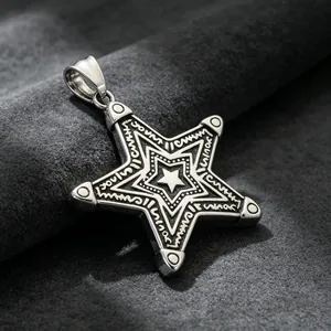 Close-up of intricate star engravings on a silver stainless steel men's pendant.