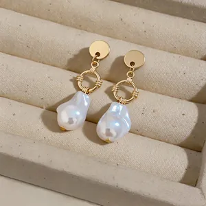 Close-up detail of French Baroque irregular pearl drop earrings with elegant gold finish